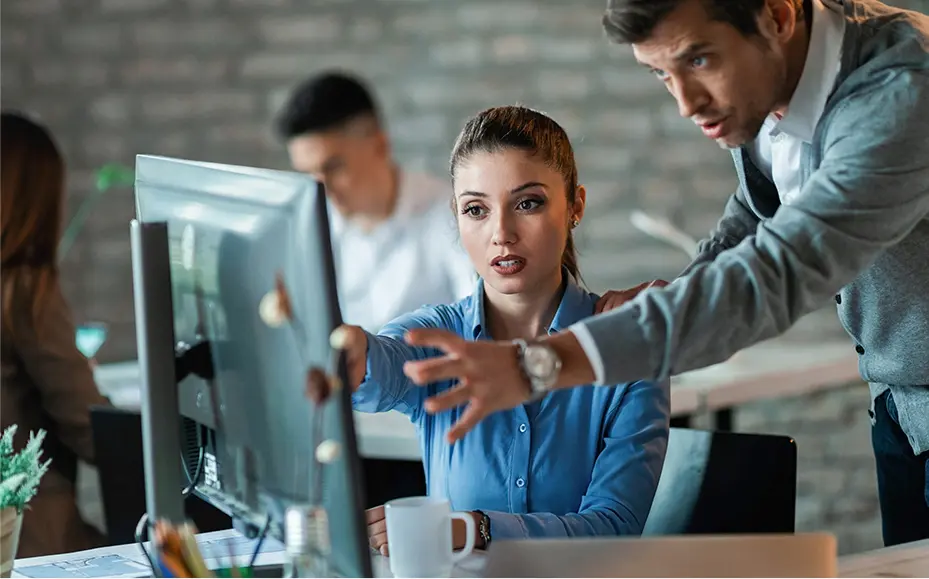 business-colleagues-using-computer-talking-about-new-project-they-are-working-office-focus-is-woman